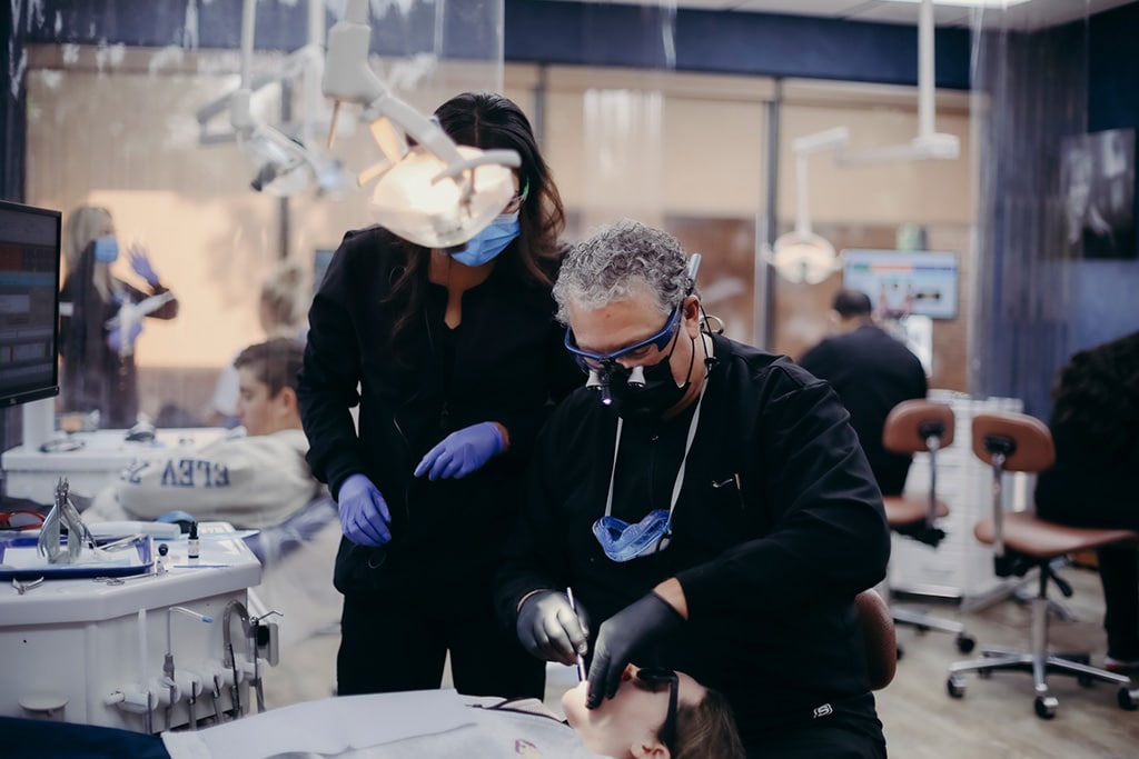 Orthodontic professionals focused on a procedure | Harwell & Cook Orthodontics