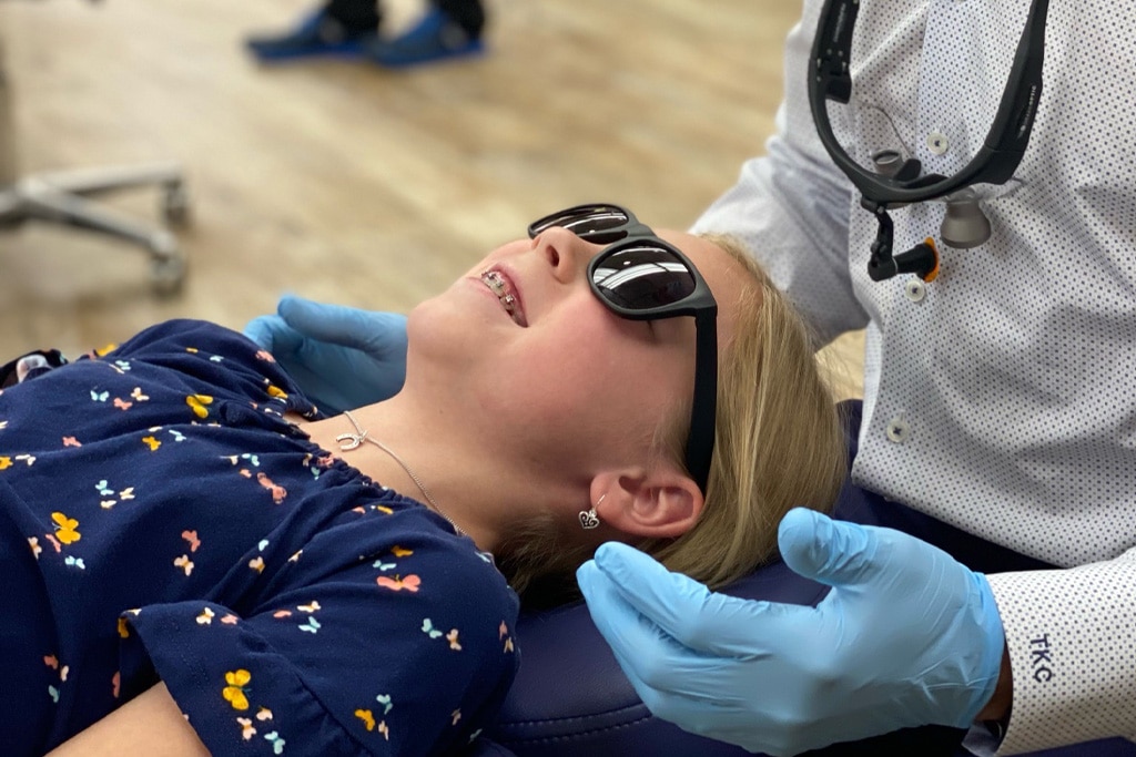 A patient wearing sunglasses during an appointment | Harwell & Cook Orthodontics
