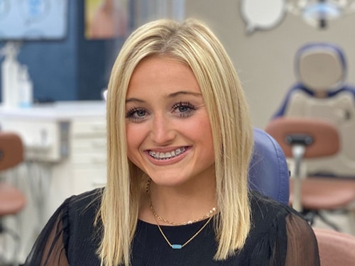 A smiling young girl with braces. | Harwell & Cook Orthodontics