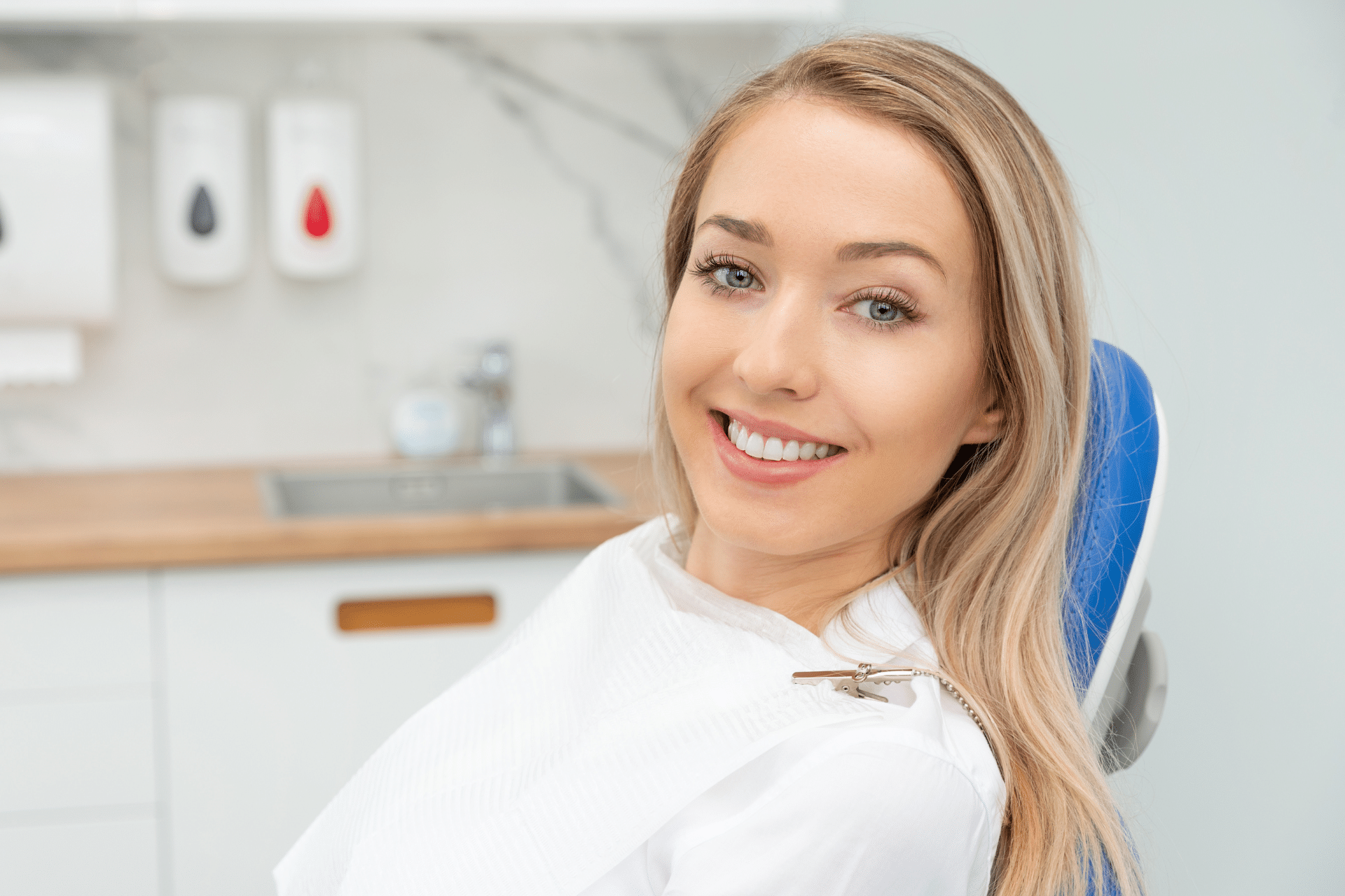 Smiling woman sitting in a dental chair during an appointment